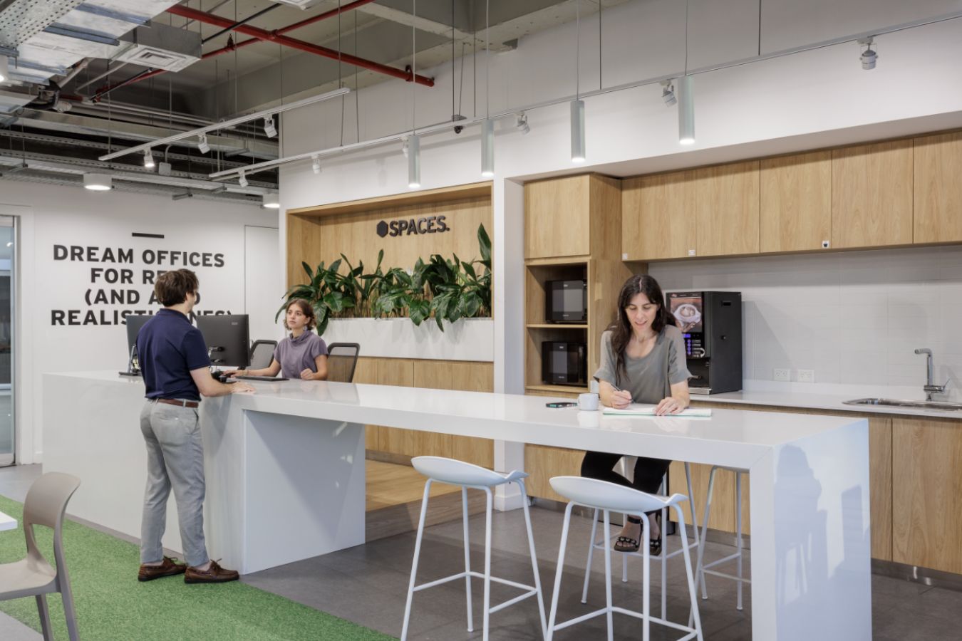 Edificio Republica - Collaborative coffee point with high community table and warm wood joinery - Contract Workplaces.jpg